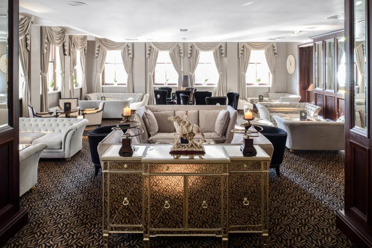 a large living room with couches and a table at The Vermont Hotel Newcastle in Newcastle upon Tyne