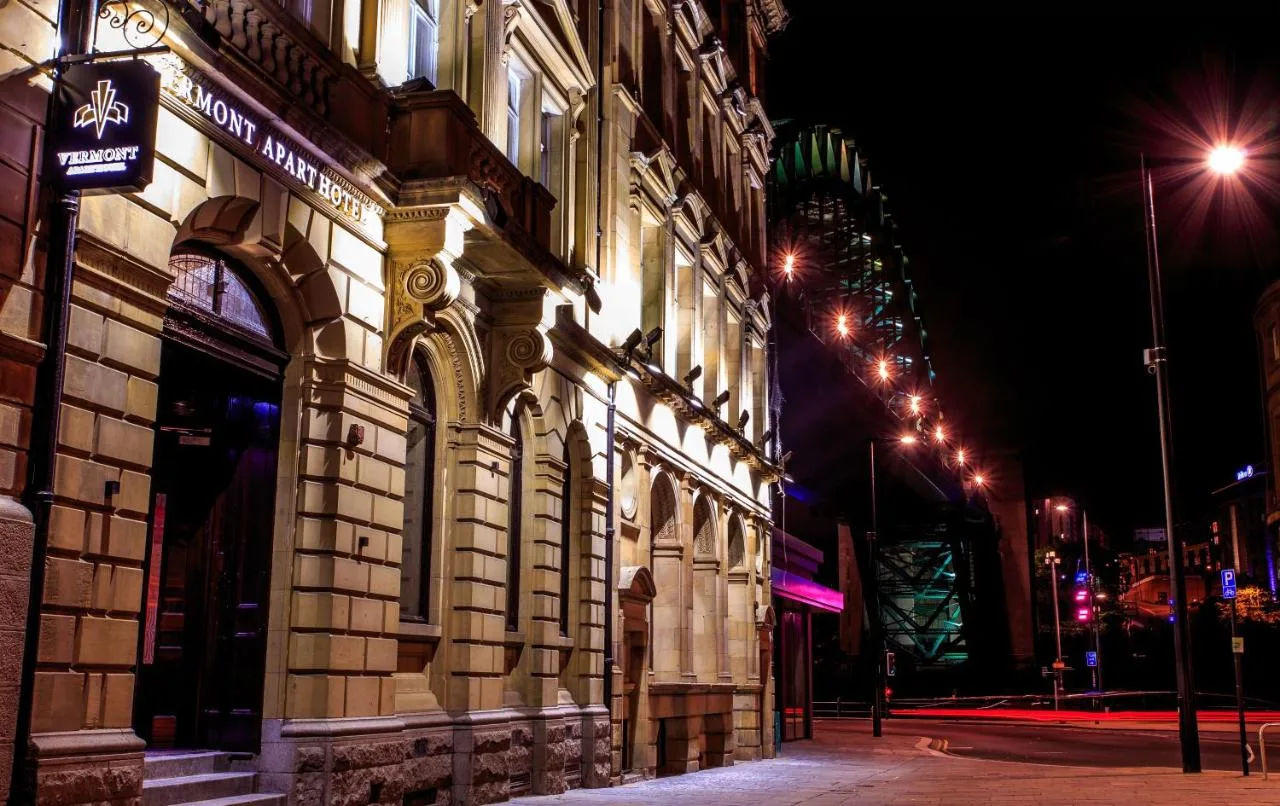 a building on the side of a street at night at The Vermont Hotel Newcastle in Newcastle upon Tyne